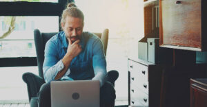 man using the internet on laptop at home