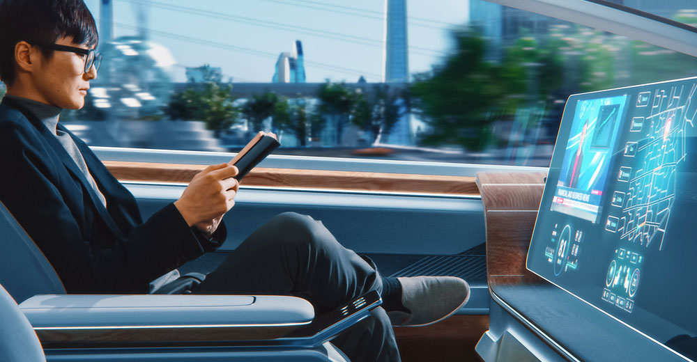passenger reading a book in an autonomous self-driving car