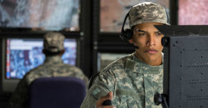 military drone operator looking at computer screen