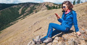 hiker in a remote location making a phone call