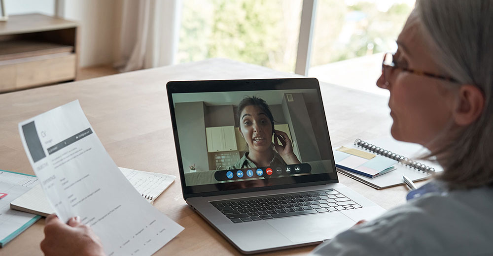 a human resources executive interviewing a job candidate in a virtual meeting